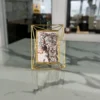 Modern geometric wire photo frame crafted from durable iron with a polished gold finish and art print insert.
