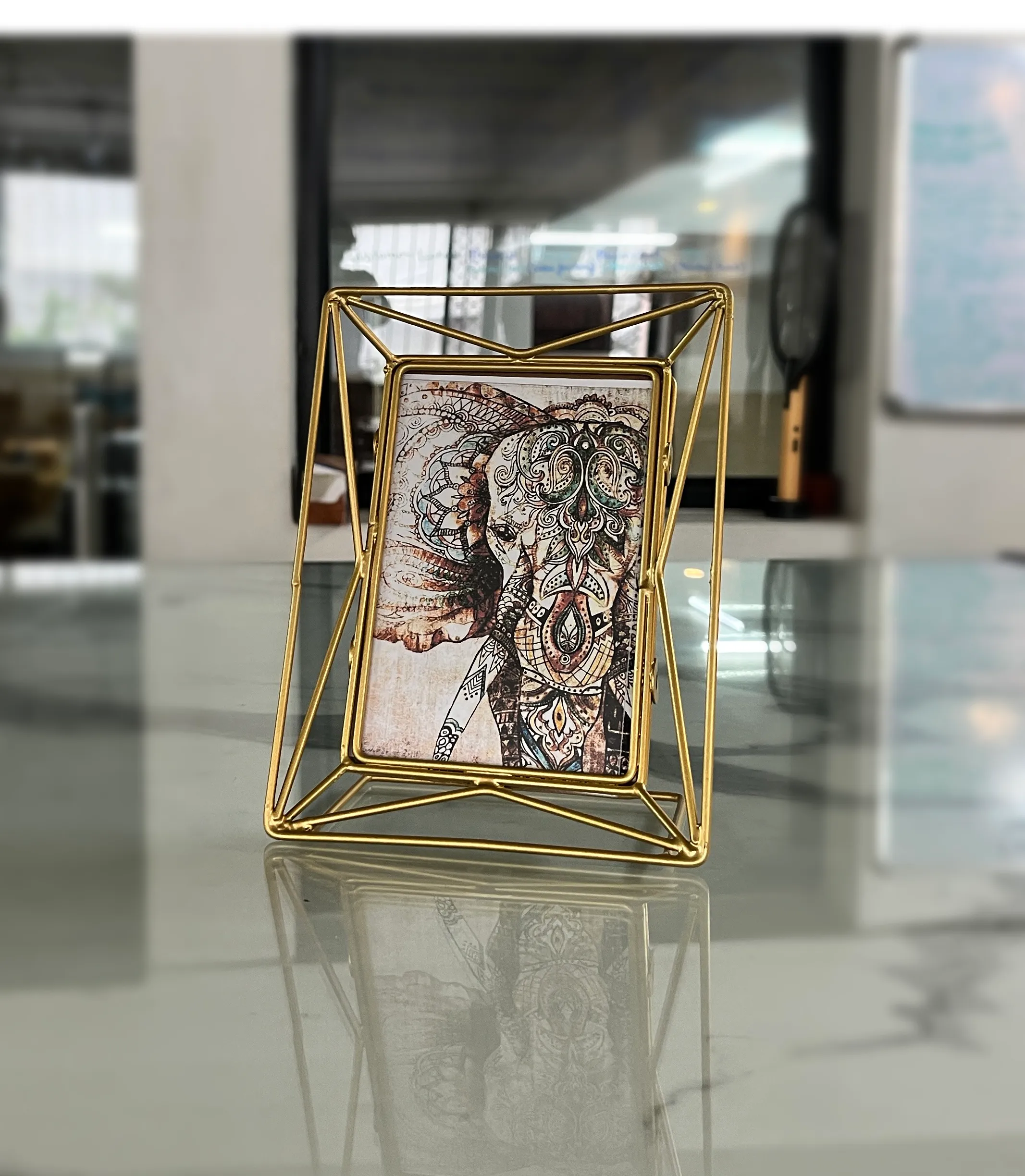Contemporary gold metal picture frame arranged as part of a Diwali festive gifting and decor collection.