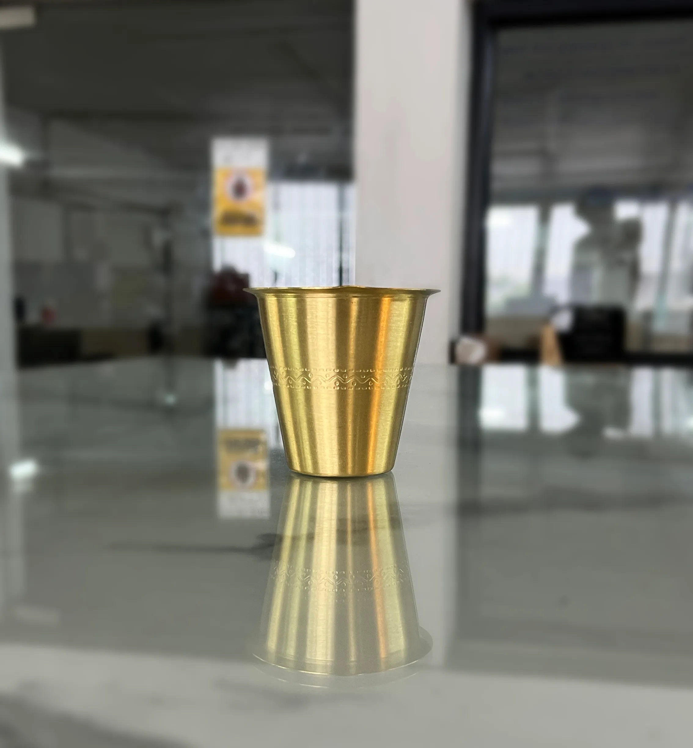 Traditional South Indian brass coffee dabarah set featuring engraved patterns and a matching tumbler.
