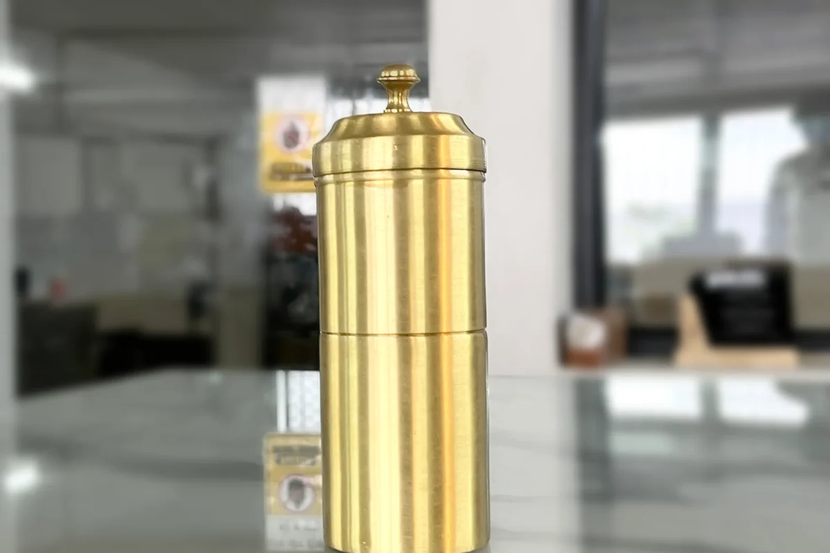 Polished brass coffee filter set arranged as part of a Diwali festive gifting and auspicious Dhanteras collection.
