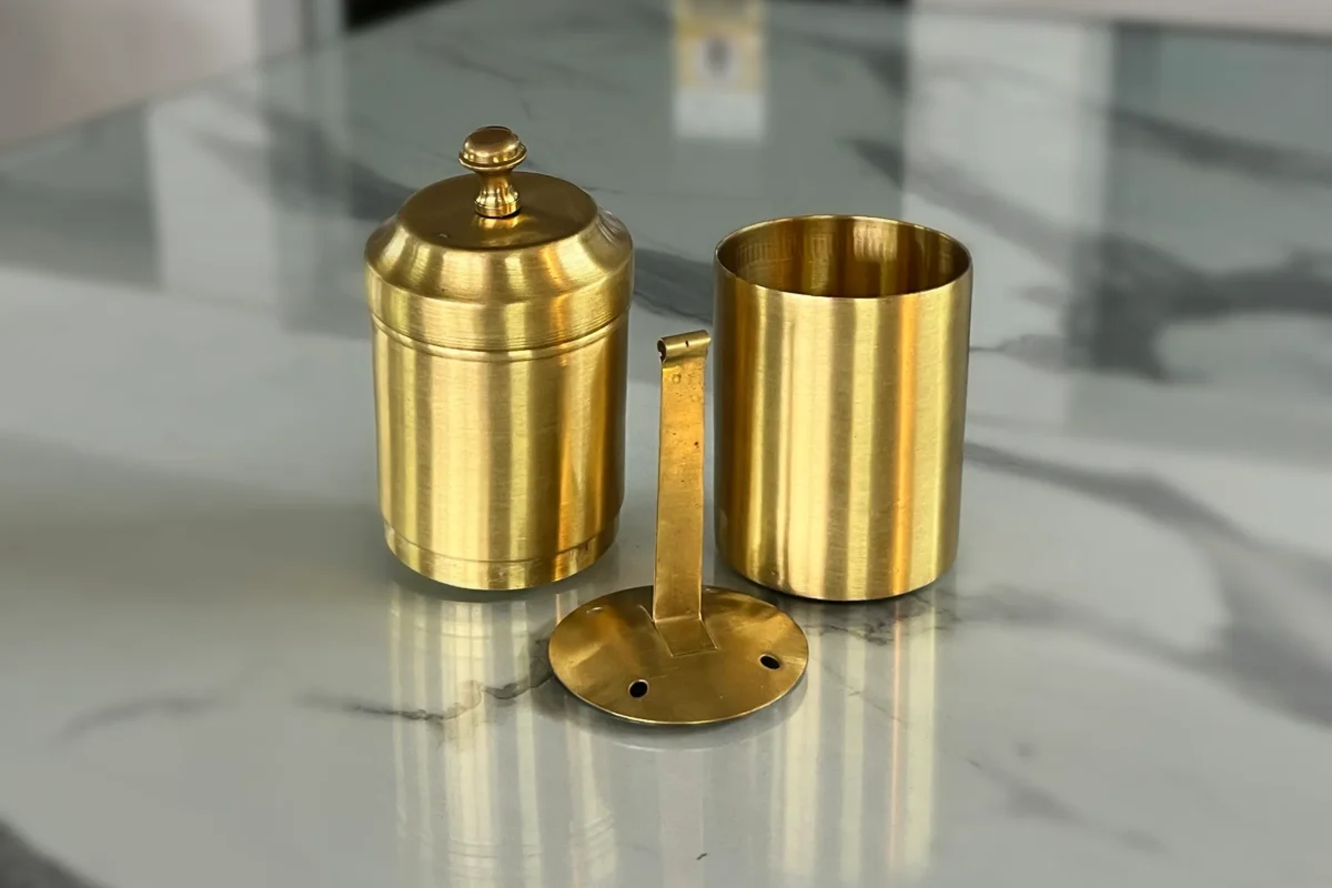 Elegant traditional brass coffee filter styled inside a luxury wedding return gift hamper for a traditional shaadi