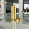 Traditional South Indian brass coffee filter set featuring dual cylindrical chambers and a matching knob lid.