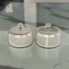 Round German silver mesh storage boxes featuring crystal-cut knob lids and intricate lattice metalwork.